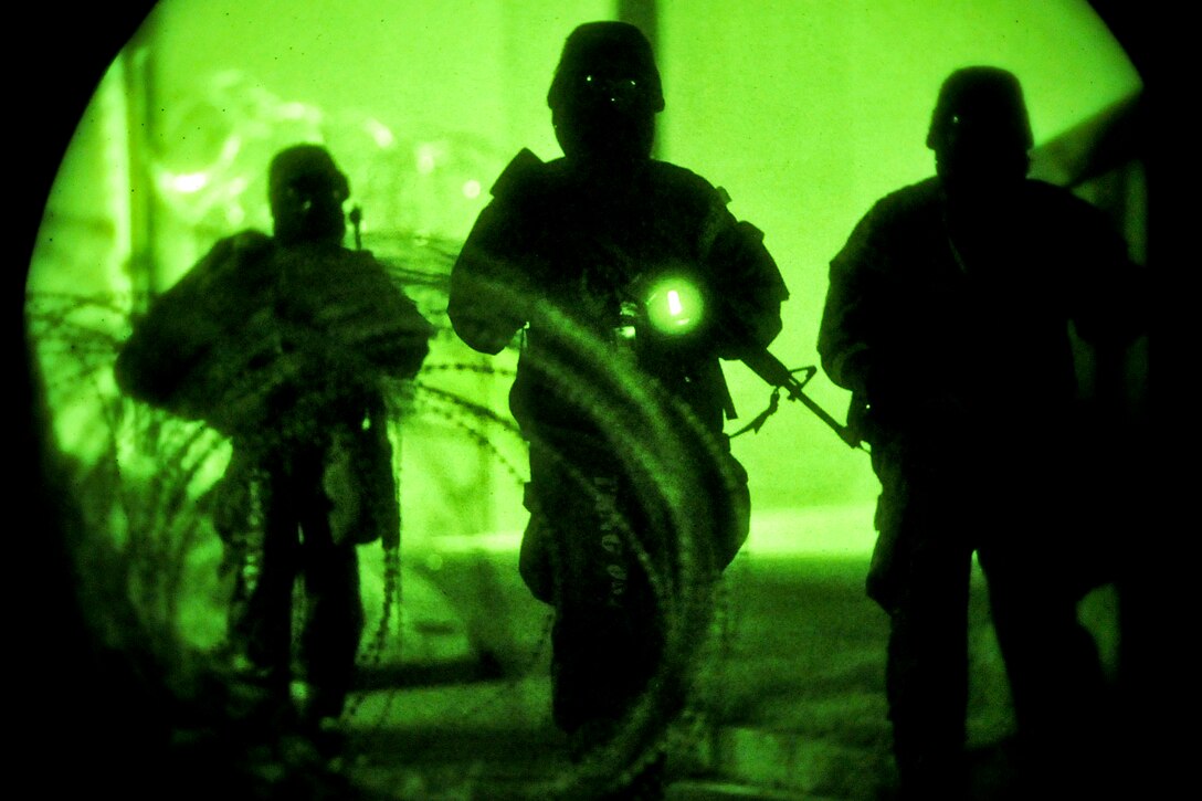Airmen respond to a ground attack during Beverly Midnight 13-03, an operational readiness exercise on Osan Air Base, South Korea, Aug. 8, 2013. The exercise is designed to test the base's ability to defend and execute the mission in a heightened state of readiness. The airmen are members of the 51st Security Forces Squadron.