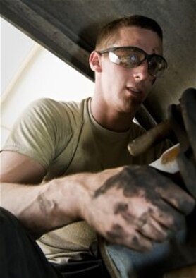 Senior Airman Dustin Franklin works on the brakes of a shuttle bus July 31, 2013, at the 379th Air Expeditionary Wing in Southwest Asia. Franklin is a 379th Expeditionary Logistics Readiness Squadron vehicle mechanic deployed from Eglin Air Force Base, Fla. (U.S. Air Force photo/Senior Airman Benjamin Stratton)