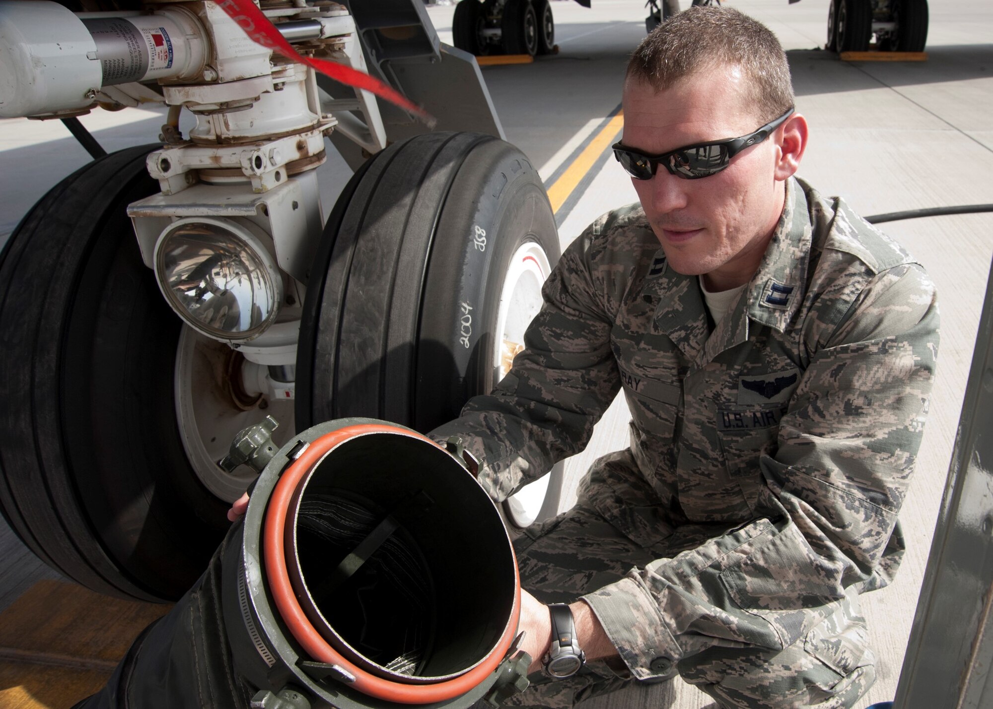 Capt. Eric Ray shows the tubing on a mobile air conditioning and heating unit prior to adding the cooling sock created by the 379th Expeditionary Operations Support Squadron aircrew flight equipment Airmen at the 379th Air Expeditionary Wing Aug. 7, 2013, in Southwest Asia. Ray is the 379th EOSS aircrew flight equipment flight officer, deployed from Altus Air Force Base, Okla.