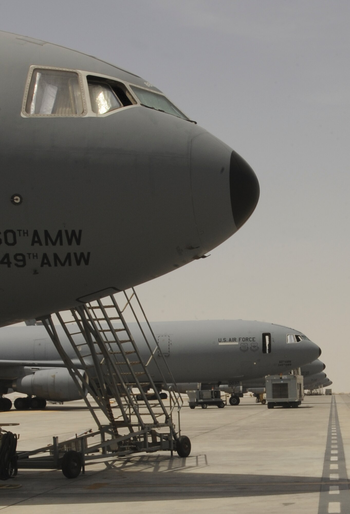 KC-10 Extenders, flown by the 908th Expeditionary Air Refueling Squadron and maintained by the 380th Expeditionary Aircraft Maintenance Squadron KC-10 Aircraft Maintenance Unit, sit on the flightline undergoing myriad maintenance inspections at an undisclosed location in Southwest Asia.  The KC-10 AMU is comprised of six specialties, who all work together as a team to keep the Extender mission ready. (U.S. Air Force photo by Staff Sgt. Jacob Morgan)