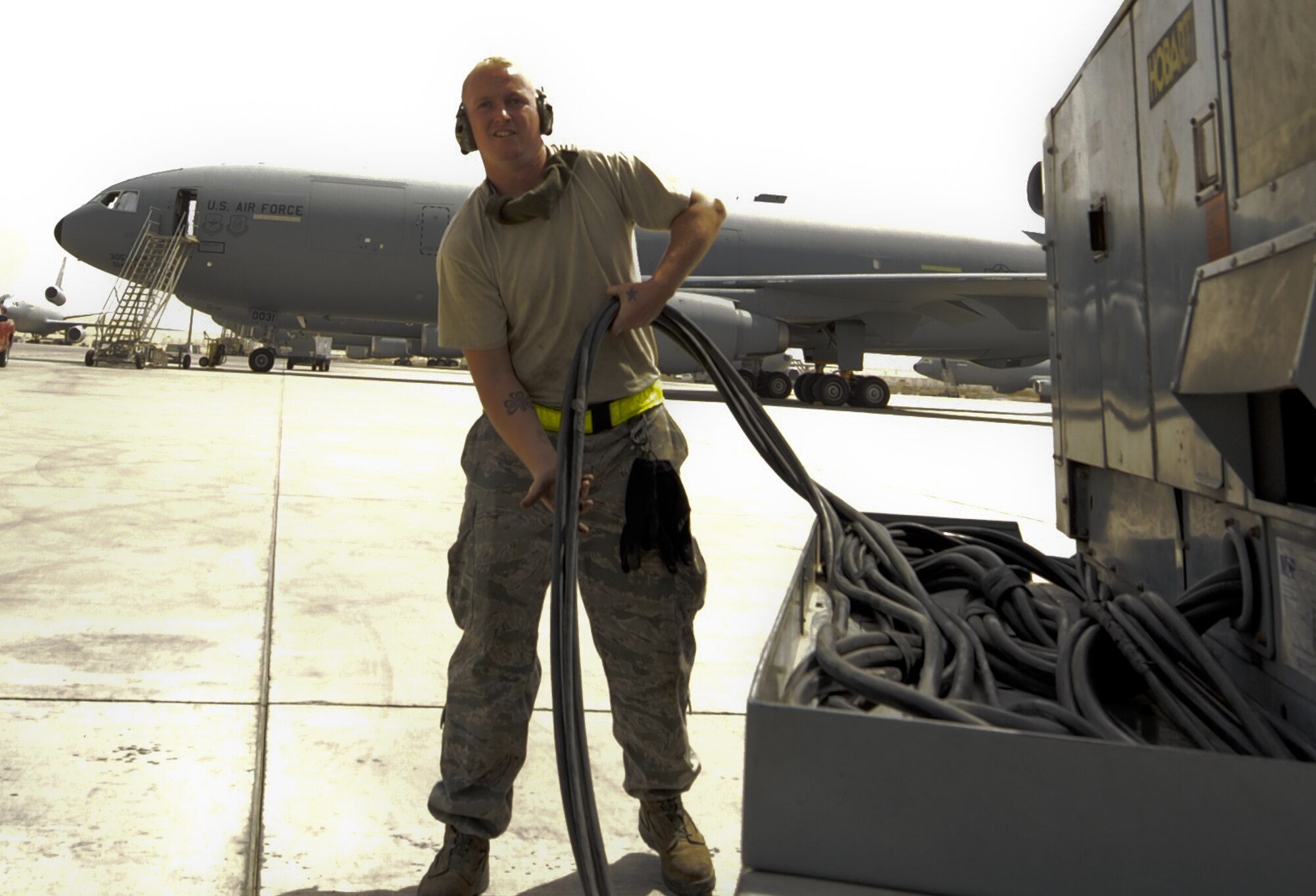 U.S. Air Force Senior Airman Robert Maeder, 380th Expeditionary Aircraft Maintenance Squadron KC-10 Aircraft Maintenance Unit aicraft hydraulic systems technician, pulls cable from a KC-10 Extender at an undisclosed location in Southwest Asia Aug. 5, 2013. Maeder is pulling the cable back to the power generator after finishing an inspection on the KC-10. Maeder calls San Francisco, Calif., home and is deployed from Travis Air Force Base, Calif. (U.S. Air Force photo by Staff Sgt. Jacob Morgan)