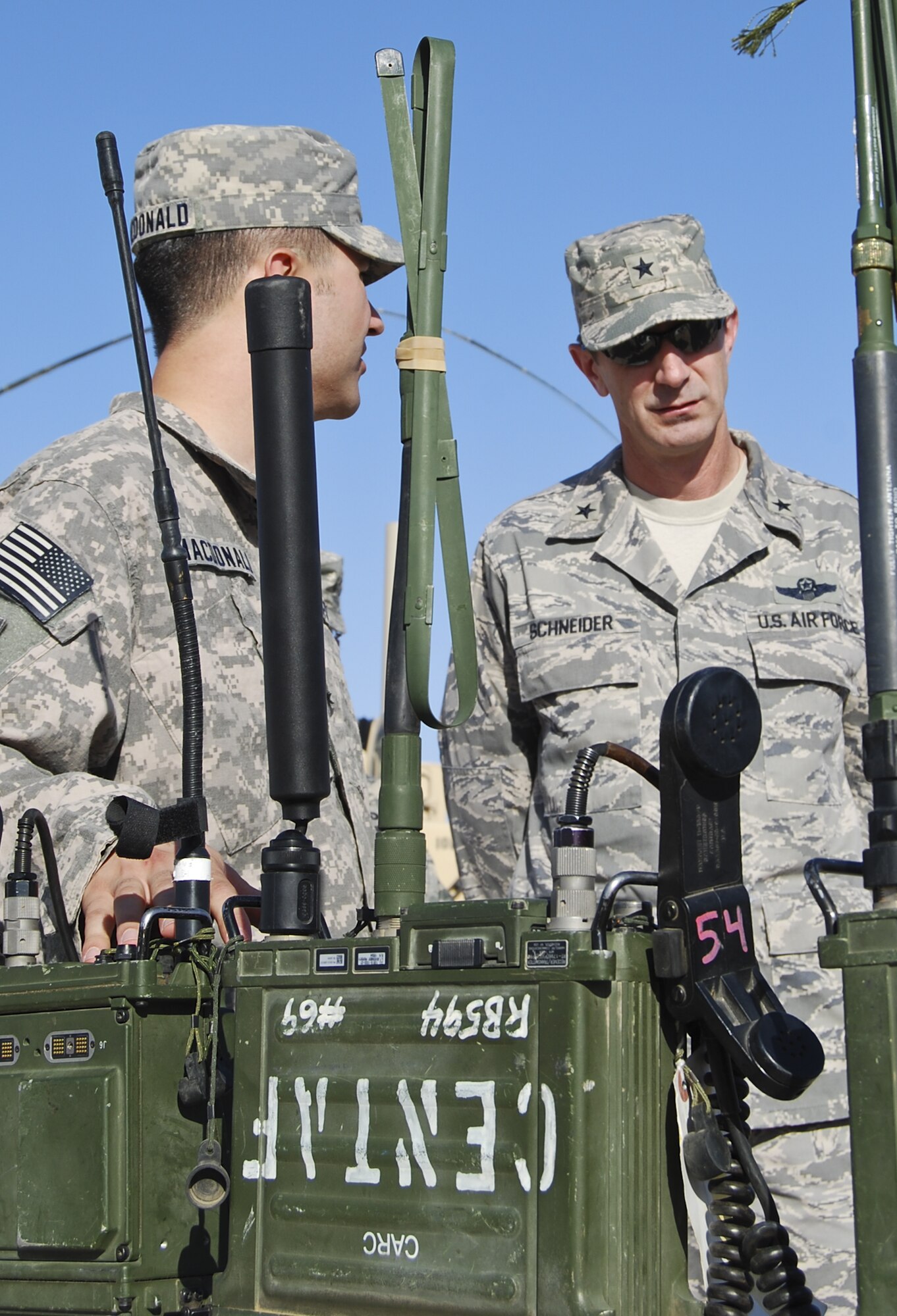 U.S. Air Force Brig. Gen. Kevin Schneider, right, 380th Air Expeditionary Wing commander, is given a tour of the facilities and equipment operated by the 82nd Expeditionary Air Support Operations Squadron at an undisclosed location in Southwest Asia Aug. 1, 2013. Schneider, along with the command chief and other staff agency chiefs visited the three geographically separated units under the 380th AEW, which support Operation Enduring Freedom and Joint Task Force Horn of Africa. (U.S. Air Force photo by Tech. Sgt. Adonis Cabarle)