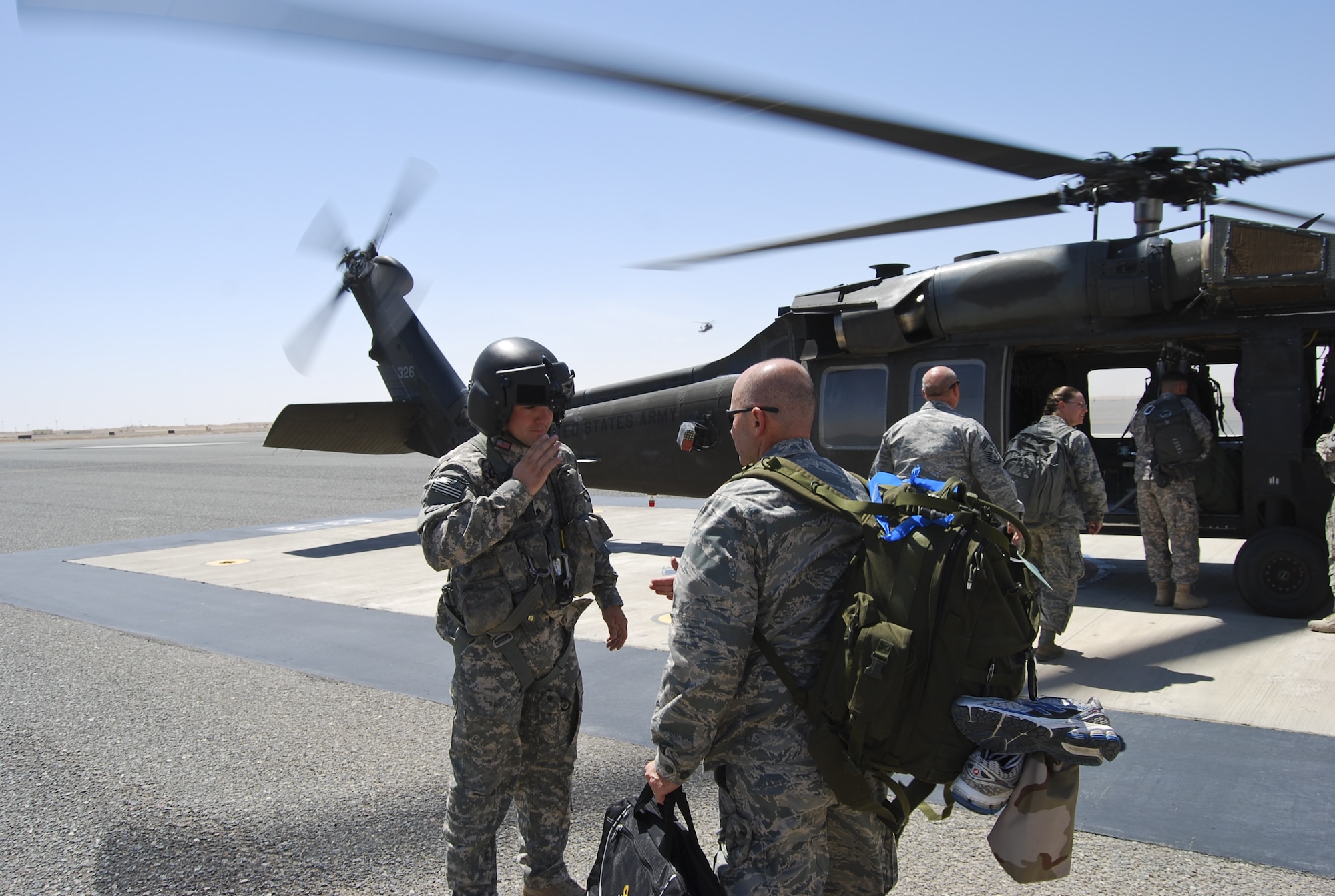 U.S. Air Force Lt. Col. Bruce Brewer, middle, 380th Air Expeditionary Wing chaplain, received a salute from a member of an Army Black Hawk helicopter flight crew at an undisclosed location in Southwest Asia Aug. 1, 2013. Brewer, along with the commander, command chief and other staff agency chiefs visited the three geographically separated units under the 380th AEW, which support Operation Enduring Freedom and Joint Task Force Horn of Africa. (U.S. Air Force photo by Tech. Sgt. Adonis Cabarle)