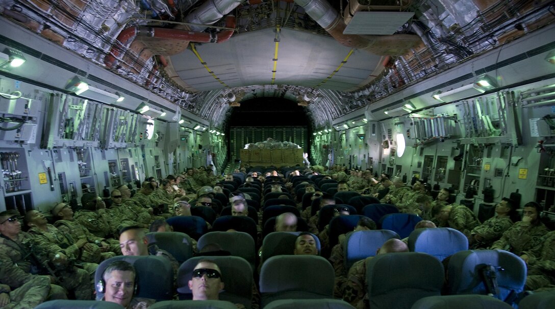 Service members are traveling to Transit Center at Manas, Kyrgyzstan on a C-17 Globemaster III, July 25, 2013. The service members and their gear were carried on the C-17 from Kandahar, Afghanistan. 