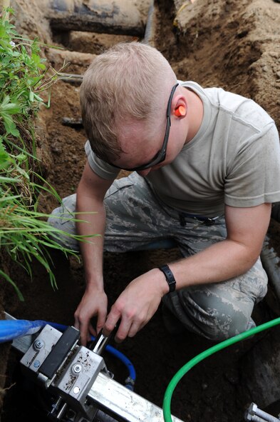 U.S. Air Force Airman 1st Class Andrew Southworth, 35th Civil Engineer Squadron structural journeyman, uses a core drill at Misawa Air Base, Japan, Aug. 8, 2013. Members of the 35 CES are laying the groundwork for fiber optic cable installation for the base's upcoming internet upgrade this fall.  (U.S. Air Force photo by Senior Airman Kia Atkins)