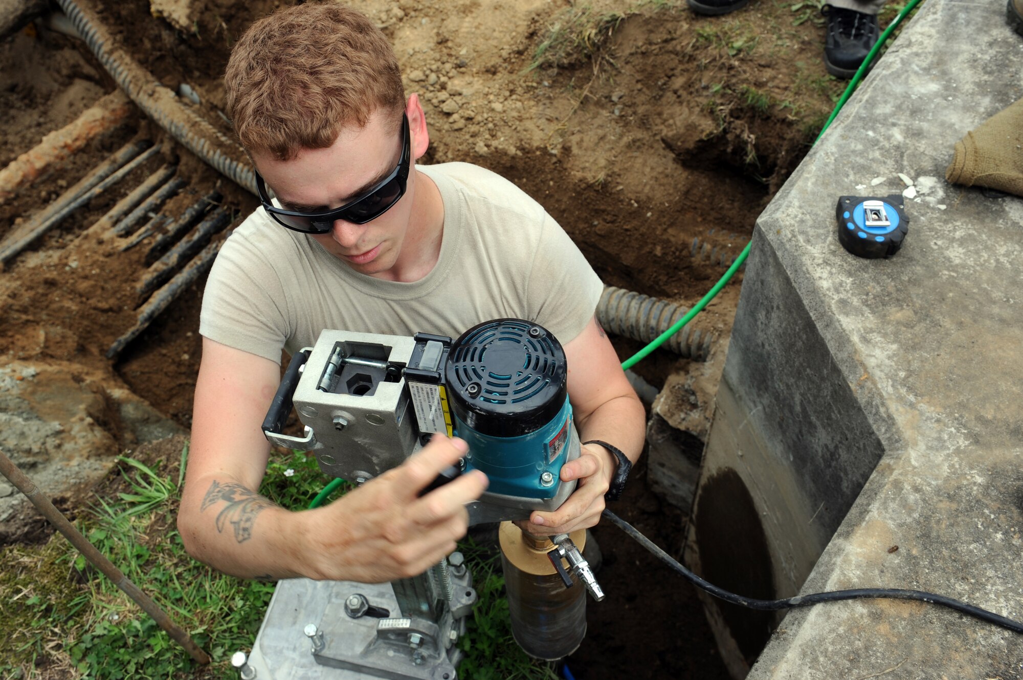 U.S. Air Force Senior Airman Hunter Stom, 35th Civil Engineer Squadron structural journeyman, places a core drill on its base at Misawa Air Base, Japan, Aug. 8, 2013. Core drilling is commonly performed to make holes for utility purposes, such as laying waste pipe and installing electrical wires. (U.S. Air Force photo by Senior Airman Kia Atkins)