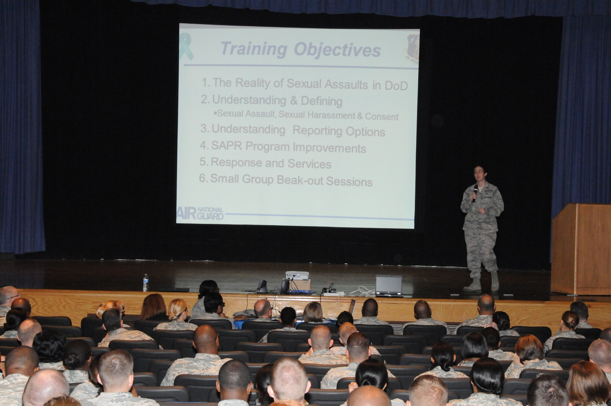 Maj. Emily J. Huffman, Sexual Assault Response Coordinator for the Va. Air National Guard, briefs airmen from the unit during the Sexual Assault Prevention & Response Stand-Down Program, August 11, 2013. The SAPR Program is designed to address sexual assault in the military and provides tools and resources for service members to use if an incident occurs. (U.S. Air National Guard photo by Master Sgt. Carlos J. Claudio/Released)