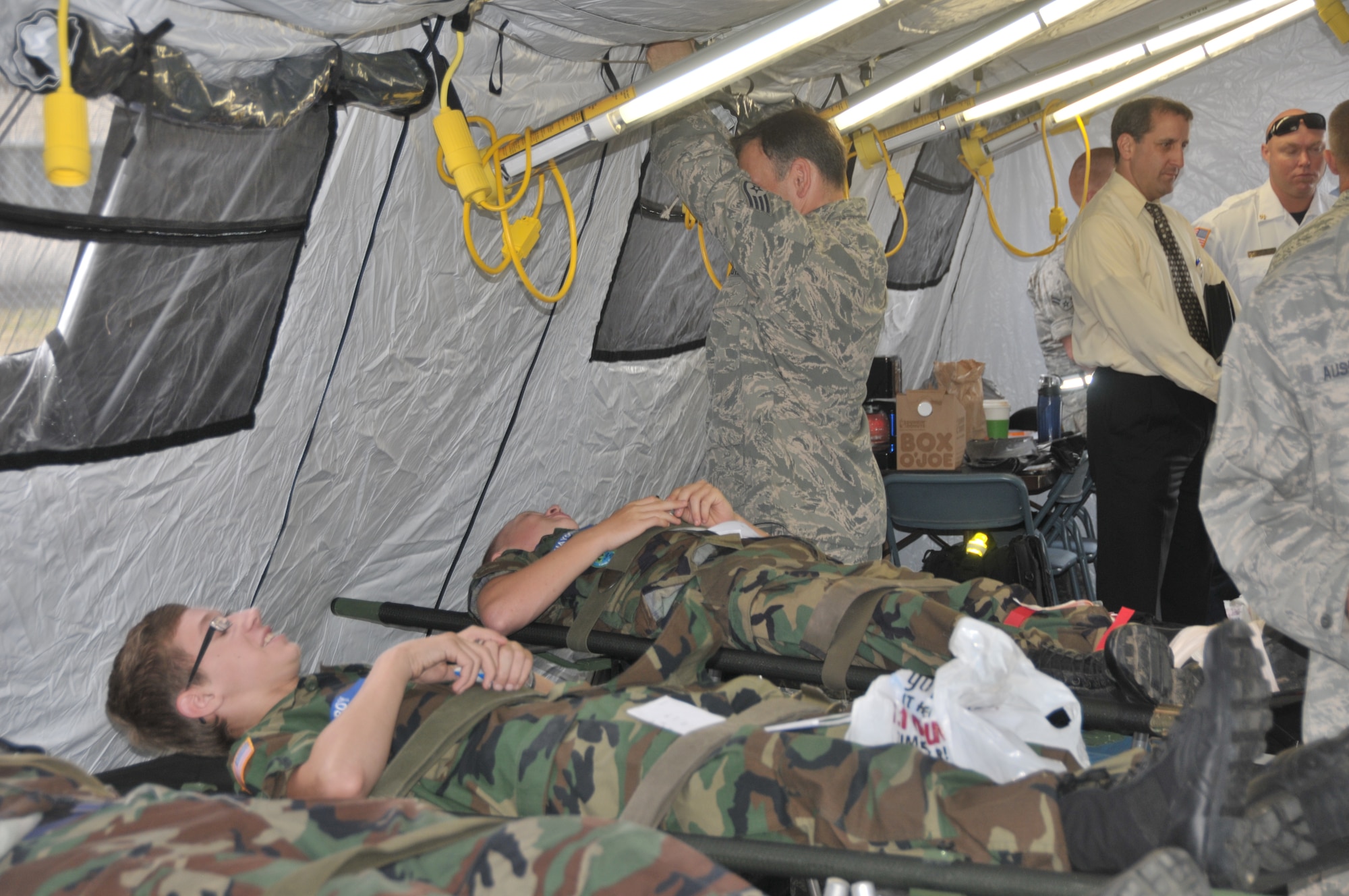 Airman from the 139th Aeromedical Evacuation Squadron of the 109th Airlift Wing, while working with civilian agencies, provide treatment during an exercise to simulated patients, Civil Air Patrol cadets, after they were brought to the base from the Aplaus Fire Department, Aug. 8, 2013. This exercise highlighted the vital function of the 109AW and 139AES in the National Disaster Medical System and homeland defense mission as well as the cooperation and coordination between the 109AW and New York state civilian medical and emergency management assets. (U.S. Air National Guard photo by Master Sgt. William M. Gizara/Released)



