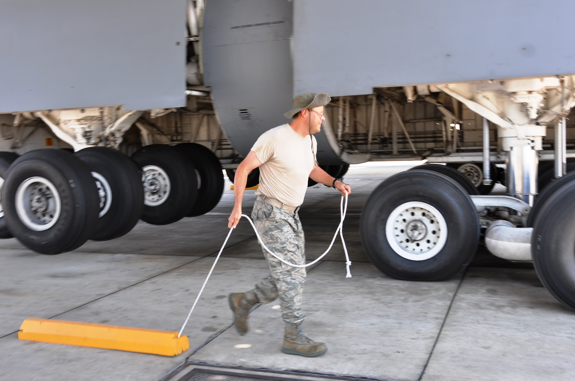 Tech Sgt. Mark Montgomery, a 433rd Airlift Wing crewcheif, wears an authorized boonie style hat on the flight line while preparing a C-5A Galaxy on the wash rack during the August Unit Training Assembly. Skin protection and frequent water breaks are important components to be aware of when working in the extreme heat. (U.S. Air Force photo by Tech Sgt. Carlos J. Trevino)