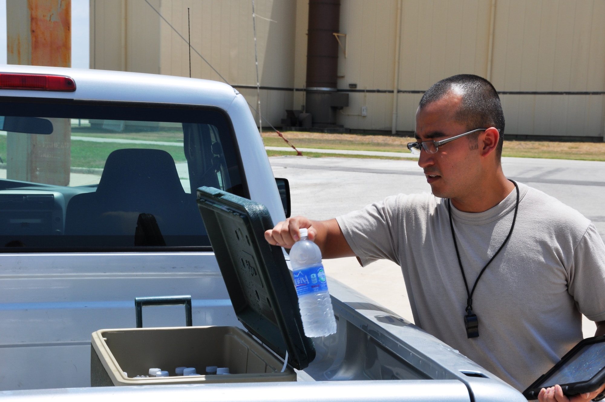 Staff Sgt. James Sanchez,  a 433rd Aircraft Maintenance Squadron crew chief, hydrates frequently while working on the flight line. According to the Airman’s Manual, “Heat can be incapacitating or deadly.”  Sanchez and his fellow crew chiefs endured temperatures of near 120 degreeswhile working on a C-5A Galaxy during here Aug 10. (U.S. Air Force photo by Tech Sgt. Carlos J. Trevino)