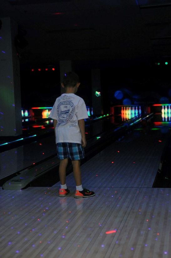 Devin, 6, watches his bowling ball roll down a lane at the Quantico Bowling Center on August 8, 2013. The Center is offering a special on glow bowling on Thursdays from 11 a.m. to 3 p.m. until the end of August. 