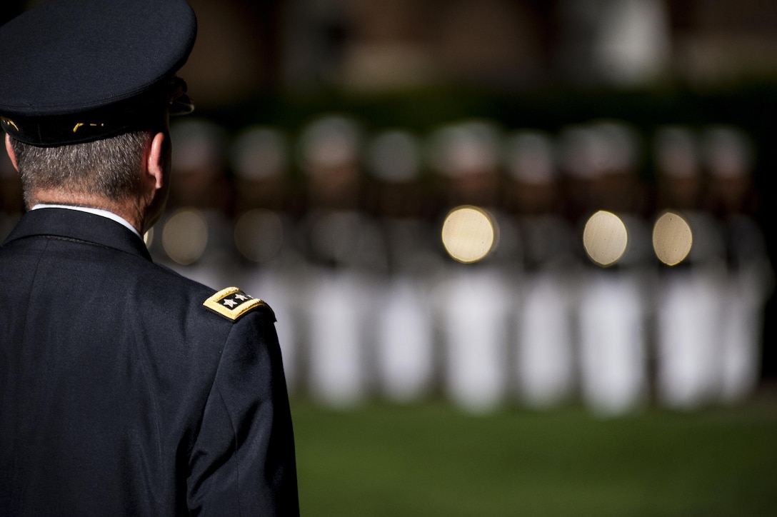 Gen. Keith Alexander, commander of U.S. Cyber Command, stands at attention as Marines from Marine Barracks Washington, D.C., pass in review during a Friday Evening Parade at the Barracks, August 9. 