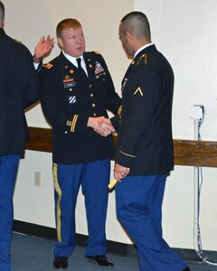 Jacob shakes hands with his battalion commander Lt. Col. Paul Struck following the graduation ceremony of his Motor Transport Operator (88M) Advanced Individual Training course at Fort Leonard Wood, Mo., March 15. 