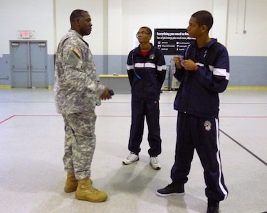 While drilling at the Kansas City armory with the Missouri Army National Guard, Pvts. Taylor and Tyler Adair receive guidance from their recruiter, Army Sgt. 1st Class Lawrence Rucker. The twin brothers will attend basic training together this summer at Fort Jackson, S.C.