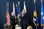 Air Force Lt. Gen. Stanley Clarke III, right, the director of the Air National Guard, receives the organizational colors of the Air National Guard from Army Gen. Frank Grass, chief, National Guard Bureau, during a ceremony March 22, 2013.