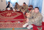 Col. Bob Hayter, center, and Maj. James Hatfield, of Kentucky's Agribusiness Development Team 5, meet with farmers and Afghan government officials in the Zharay District, Jan. 23, 2013. The meeting brought roughly 200 farmers together to discuss potential improvements in farming in the area.