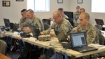 New York Army and Air National Guard officers and noncommissioned officers assigned to the Joint Operations Staff work in an ad hoc Joint Operations Center during a Continuity of Operations exercise March 27, 2013.