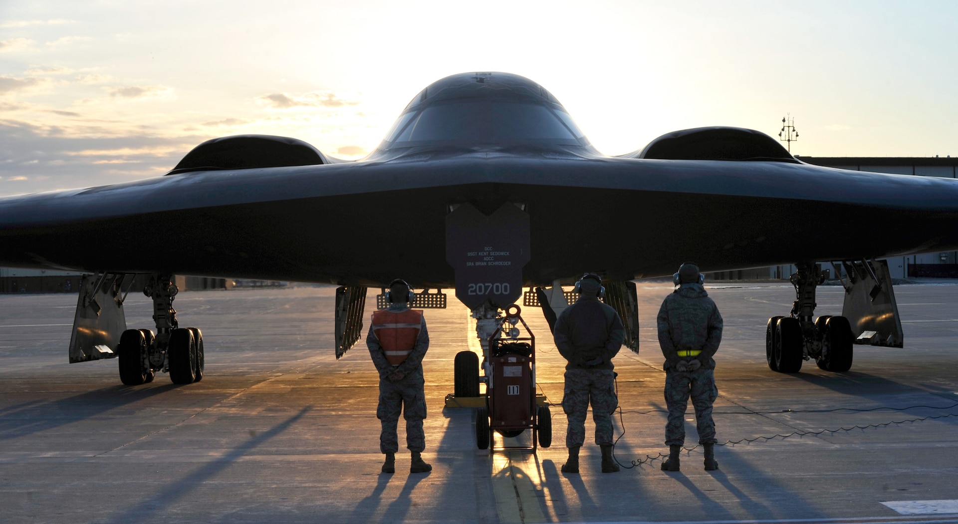 U.S. Air Force B-2 Spirit crew chiefs stand ready to perform maintenance on the "Spirit of Florida" after completing a historic training mission in which it became the first B-2 to reach 7,000 flight hours, Whiteman Air Force Base, Mo., April 1, 2013.