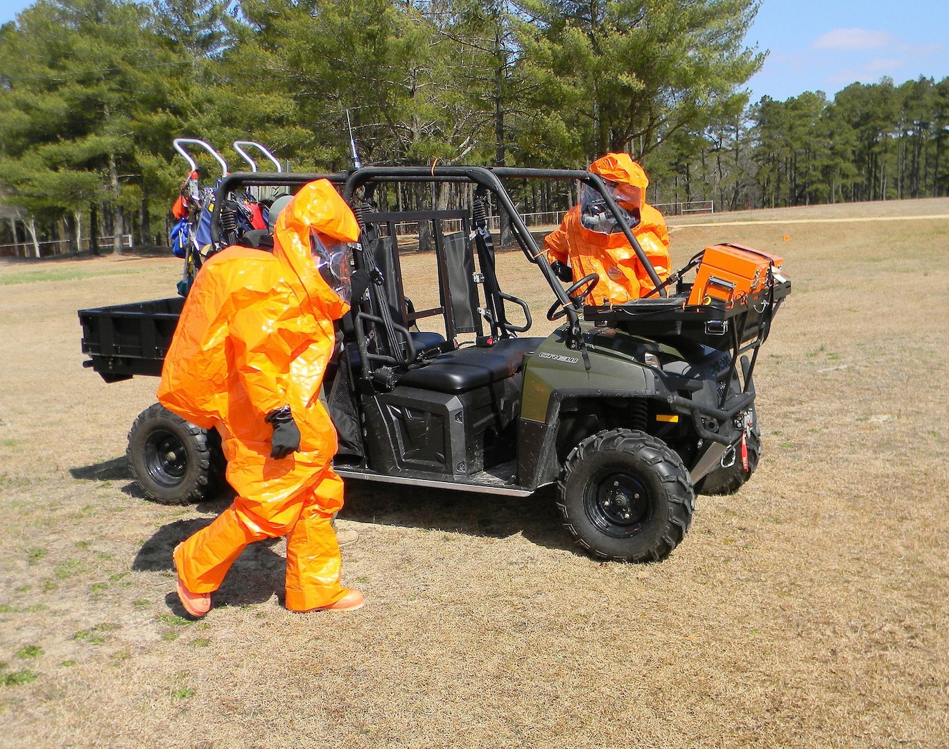 Two members of the North Carolina National Guard's 42nd Civil Support Team's survey section prepare for transport on a Polaris quad track vehicle to a simulated Chemical, Biological, Radiological, Nuclear and of Explosive (CBRNE) incident site during the unit's evaluation March 28, 2013.