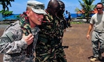 U.S. Army 2nd Lt. Justin Gilliam, Medical Section, 2nd Battalion, 138th Field Artillery, teaches members of the Comoros military various buddy carries in Moroni, Comoros, Jan. 23, 2013.