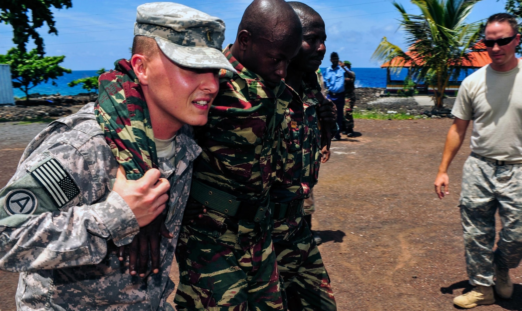 U.S. Army 2nd Lt. Justin Gilliam, Medical Section, 2nd Battalion, 138th Field Artillery, teaches members of the Comoros military various buddy carries in Moroni, Comoros, Jan. 23, 2013.