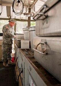 Sgt. 1st Class Edward Haggett begins preparing the evening meal at Military District Six for soldiers assigned to Beyond the Horizon-El Salvador, April 1, 2013.