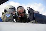 Gen. Tito Saul Pinilla Pinilla, commander of the Colombian Air Force, speaks with Lt. Col. Scott Bridgers, 169th Aircraft Maintenance Squadron commander and F-16 fighter pilot, during his tour of McEntire Joint National Guard Base, S.C., April 8, 2013.