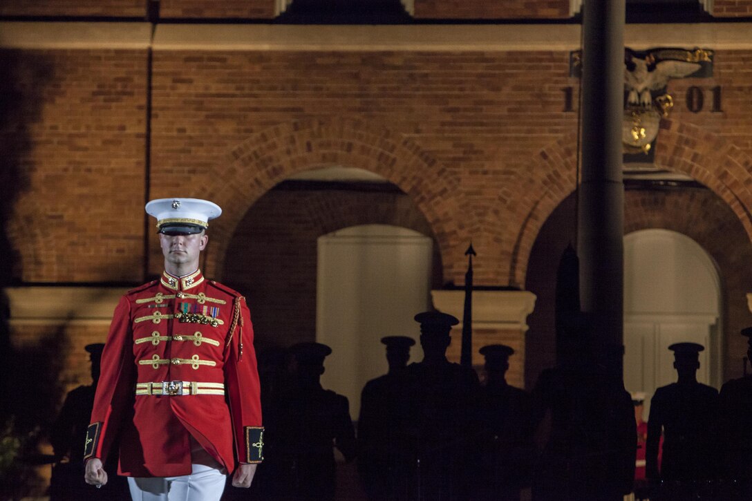 Chief Warrant Officer James D. Foley, U.S. Marine Drum & Bugle Corps assistant director, marches to his position during a Friday Evening Parade at Marine Barracks Washington, D.C., Aug. 3. 