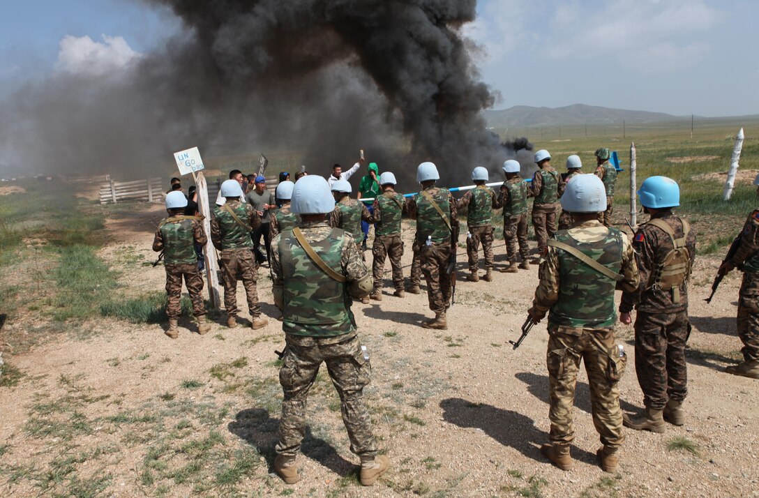 Soldiers with the Mongolian Armed Forces role play as both rioters and peacekeepers while training on the vehicle checkpoint lane, Aug. 8. Khaan Quest is a peacekeeping operations-focused, combined training event between U.S. Marine Corps Forces Pacific, U.S. Army Pacific, and the MAF. MARFORPAC and USARPAC have conducted similar training with MAF since 2003, and this exercise marks the 11th iteration of Khaan Quest. Military personnel from Australia, Canada, France, Germany, Japan, India, Nepal, Republic of Korea, Tajikistan, United Kingdom and Vietnam are also participating in the exercise.