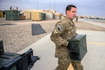 U.S. Air Force Senior Airman Austin Stoker, a munitions systems specialist deployed to the 26th Expeditionary Rescue Squadron, replenishes a .50-caliber machine gun after a training mission over an undisclosed location in Afghanistan, March 11, 2013.