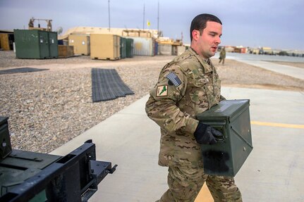 U.S. Air Force Senior Airman Austin Stoker, a munitions systems specialist deployed to the 26th Expeditionary Rescue Squadron, replenishes a .50-caliber machine gun after a training mission over an undisclosed location in Afghanistan, March 11, 2013.