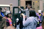 Staff Sgt. Luis Berdecia of the 138th Fires Brigade supervises as children climb inside for a look during the 2013 Student Technology Leadership Program in Lexington, Ky., March 28, 2013.