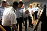 Members of the Colorado National Guard examine the newest National Guard Heritage painting at the Army National Guard Readiness Center in Arlington, Va., April 10, 2013. The painting depicts the actions of the Colorado Army Guard during the Civil War.