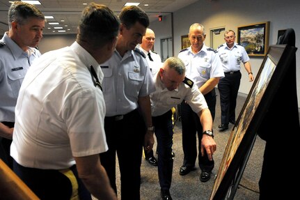 Members of the Colorado National Guard examine the newest National Guard Heritage painting at the Army National Guard Readiness Center in Arlington, Va., April 10, 2013. The painting depicts the actions of the Colorado Army Guard during the Civil War.