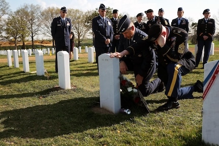 Air Force Maj. Gen. H. Michael Edwards, left, the adjutant general of the Colorado National Guard, and Command Sgt. Maj. Rob Lawrence, the senior enlisted leader to the adjutant general, pay their final respects at the headstone of crewmembers of Extortion 17 during a ceremony at Arlington National Cemetery, Wednesday, April 10, 2013.