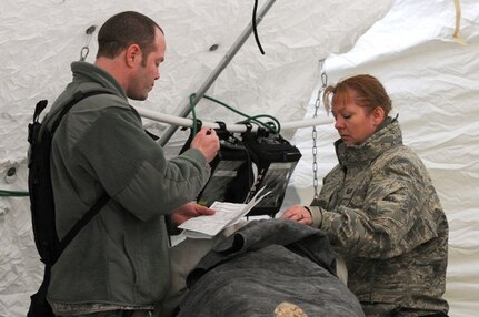 Capt. Scotty A. Duranceau of St. Louis, a clinical nurse and Tech Sgt. Leslie A. Green of Paducah, Ky., a medical technician, both with the 126th Medical Group, triage a patient during the drill.