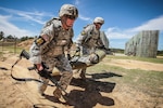 The Wisconsin Army National Guard's 1st Lt. Nicholas Plocar, left, and Georgia Army National Guard's 1st Lt. Travis Cornwall drag a 200-pound mannequin during competition.