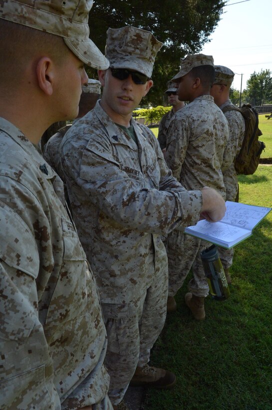 Sgt. Sean Hackney, a student and team chief at the Marine Corps Civil-Military Operations School, explains some of his team’s findings after an infrastructure assessment exercise Aug. 2, 2013, at Marine Corps Base Quantico. MCCMOS students are required to grasp the concepts taught at the schoolhouse prior to graduation.
