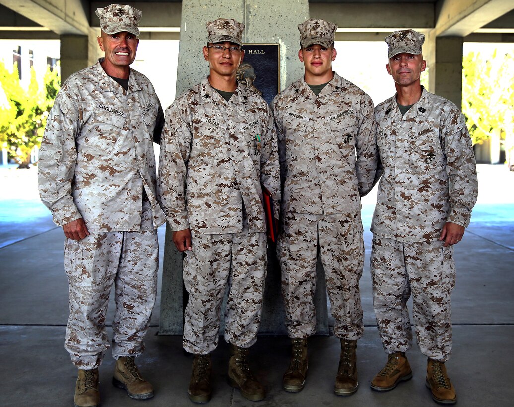 Brig. Gen. Vincent A. Coglianese, left, and Sgt. Maj. Scott R. Helms, right, pose with Sgt. Julio C. Tovar, center- left, and Cpl. Jared Brittain, center-right, after the NCO of the quarter ceremony held in the courtyard of building 1160 here August 12. Tovar was awarded the Navy and Marine Corps Achievement Medal and won NCO of the Quarter for Marine Corps Installations-West. Brittain won NCO of the Quarter for Marine Corps Base Camp Pendleton. Coglianese is base commanding general and regional authority for five Marine Corps installations in the Southwestern United States. Helms is the base sergeant major and five Marine Corps installations in the Southwestern United States.