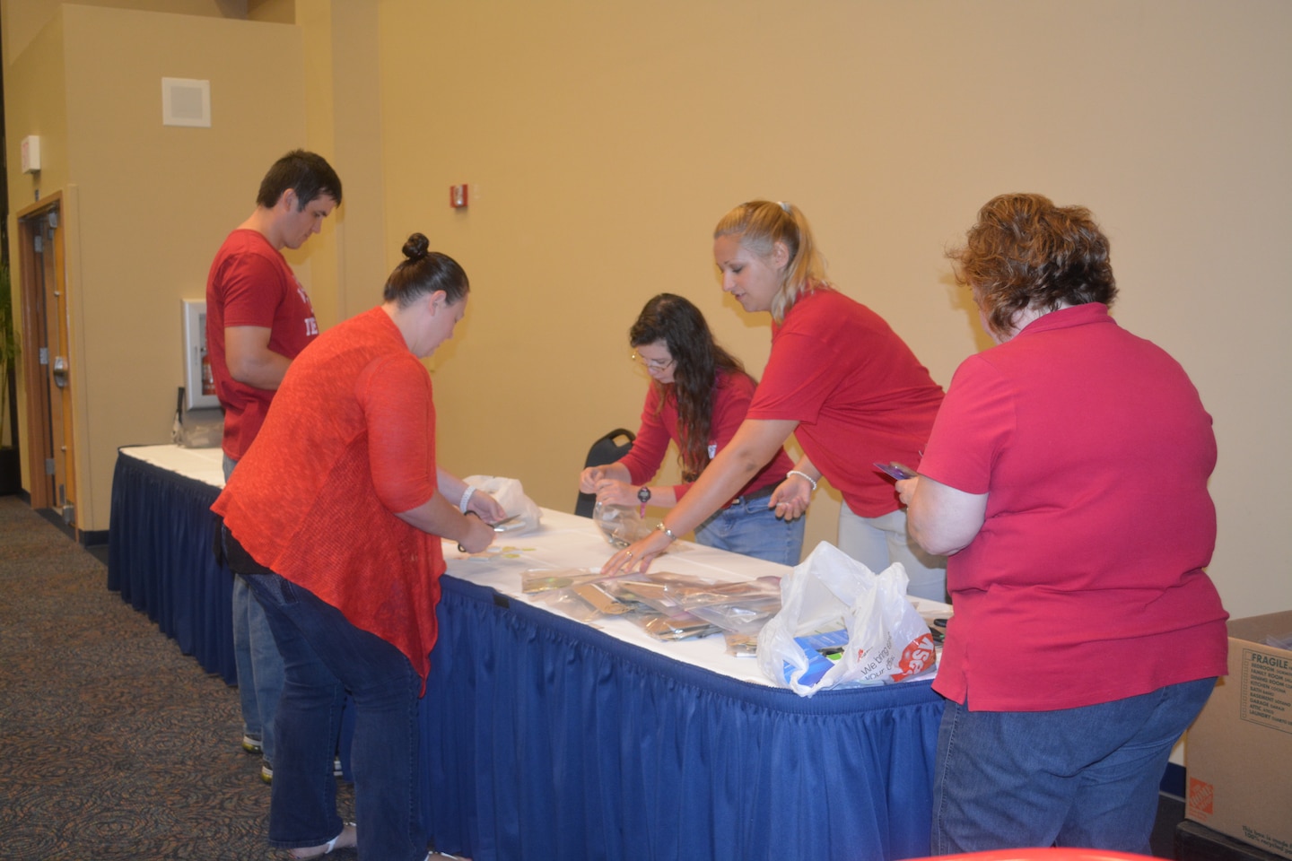 Volunteers (left to right) Alex Schur, Pam Winant, Stephanie Raulerson, Viktoria Bogina and Susan Copeland prepare materials for student challenges at the Second Annual STEM Camp held at the University of North Florida. 