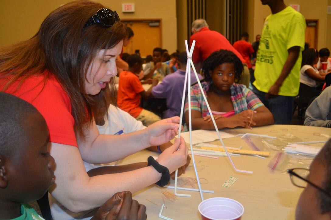 Civil engineer Jessamyn Fluitt, Engineering Division, assists students with the water tower construction at the one-day STEM event at the University of North Florida. 