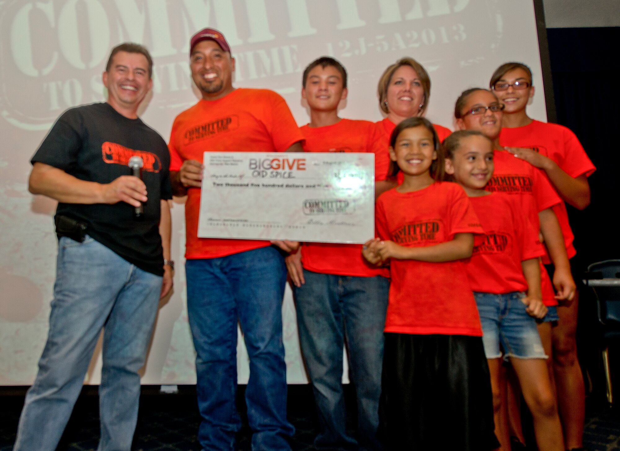 Members from the Big Give team “Old Spice” accepts a check after winning the small team Big Give Award at the Desert Sands Enlisted Club at Holloman Air Force Base N.M., Aug. 9. Old Spice, a team comprised of a single family, won $2,500 for their project helping two families with household maintenance and assisting the Alamogordo High School baseball team with ballpark renovations. (U.S. Air Force photo by Airman 1st Class Chase Cannon / Released)