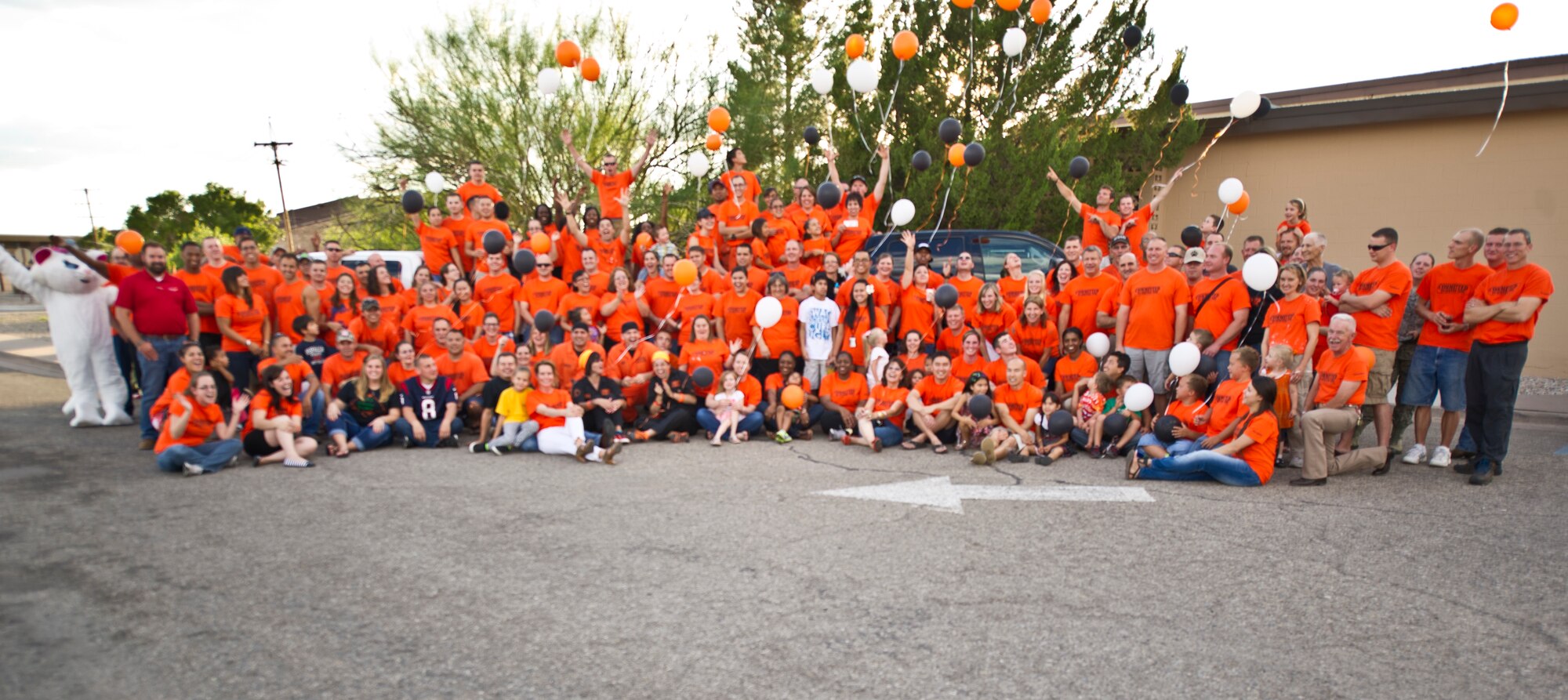 Participants in the Big Give 2013 pose for a group photo during the award ceremony outside the Desert Sands Enlisted Club at Holloman Air Force Base, N.M., Aug 9. The Big Give is an annual event hosted by the 49th Force Support Squadron, in which teams of people dedicate their time, money and efforts to give back to the community. (U.S. Air Force photo by Airman 1st Class Chase Cannon / Released) 