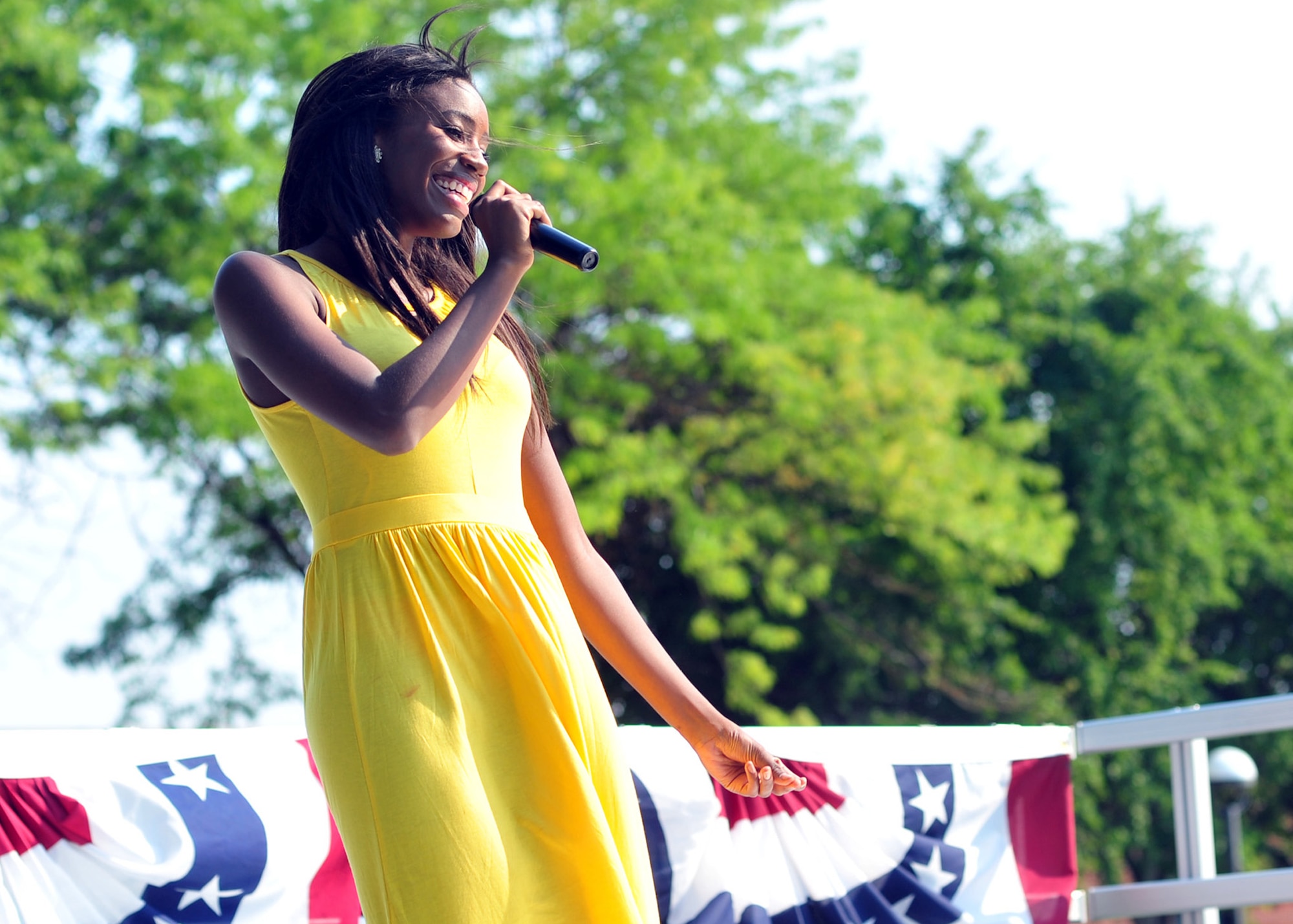 2nd Lt. Rachelle Smith performs during the Air Mobility Command Icon, a Karaoke style singing competition, during the base picnic at Fairchild Air Force Base, Wash., Aug. 9, 2013. There were a total of 12 participants in the competition. (U.S. Air Force photo by Senior Airman Taylor Curry/Released)