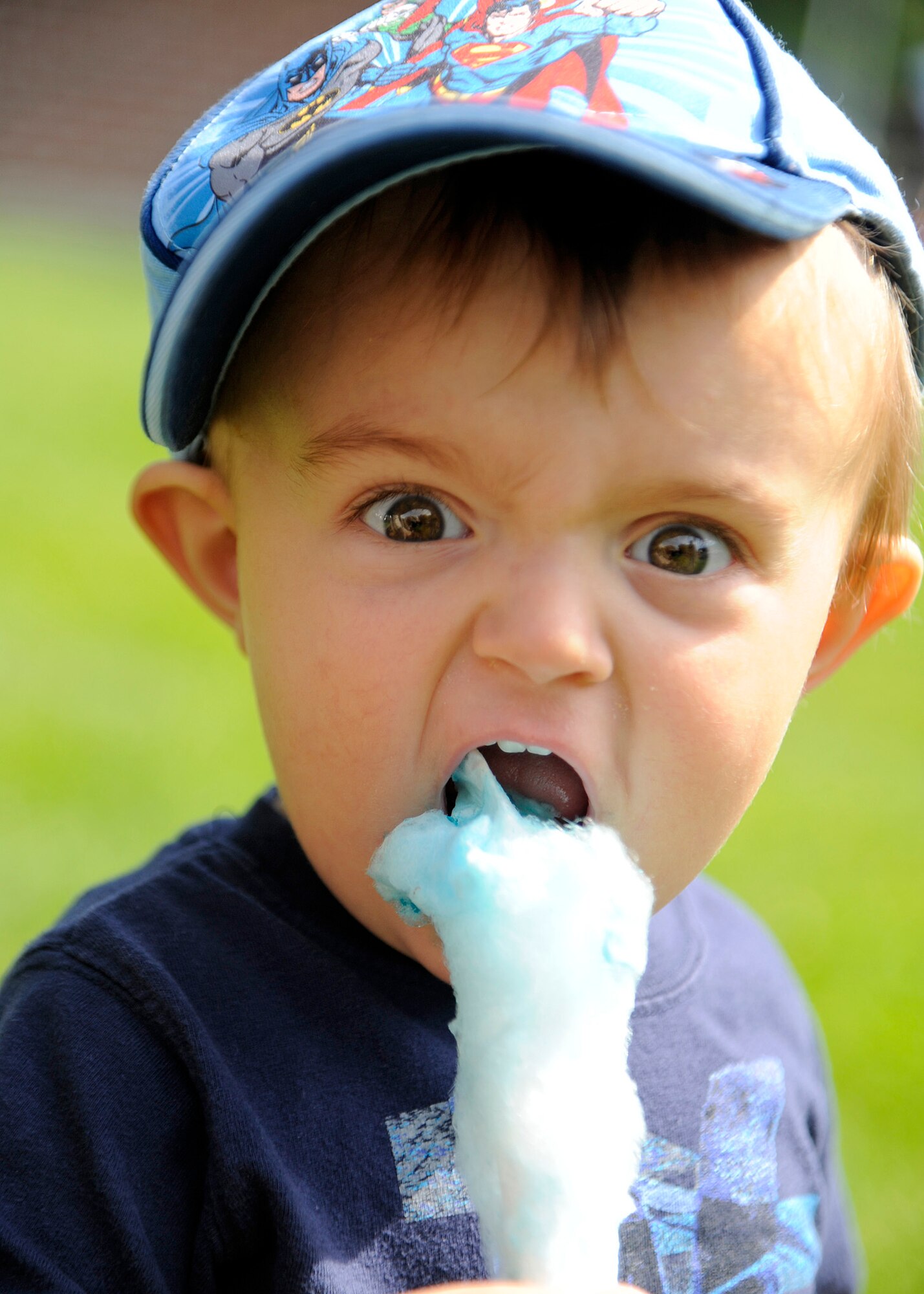 Donovan Thorndill eats cotton candy during the base picnic at Fairchild Air Force Base, Wash., Aug. 9, 2013. The picnic held many activities such as face painting, airbrush tattoos, a bungee trampoline and a rock wall. (U.S. Air Force photo by Senior Airman Taylor Curry/Released)