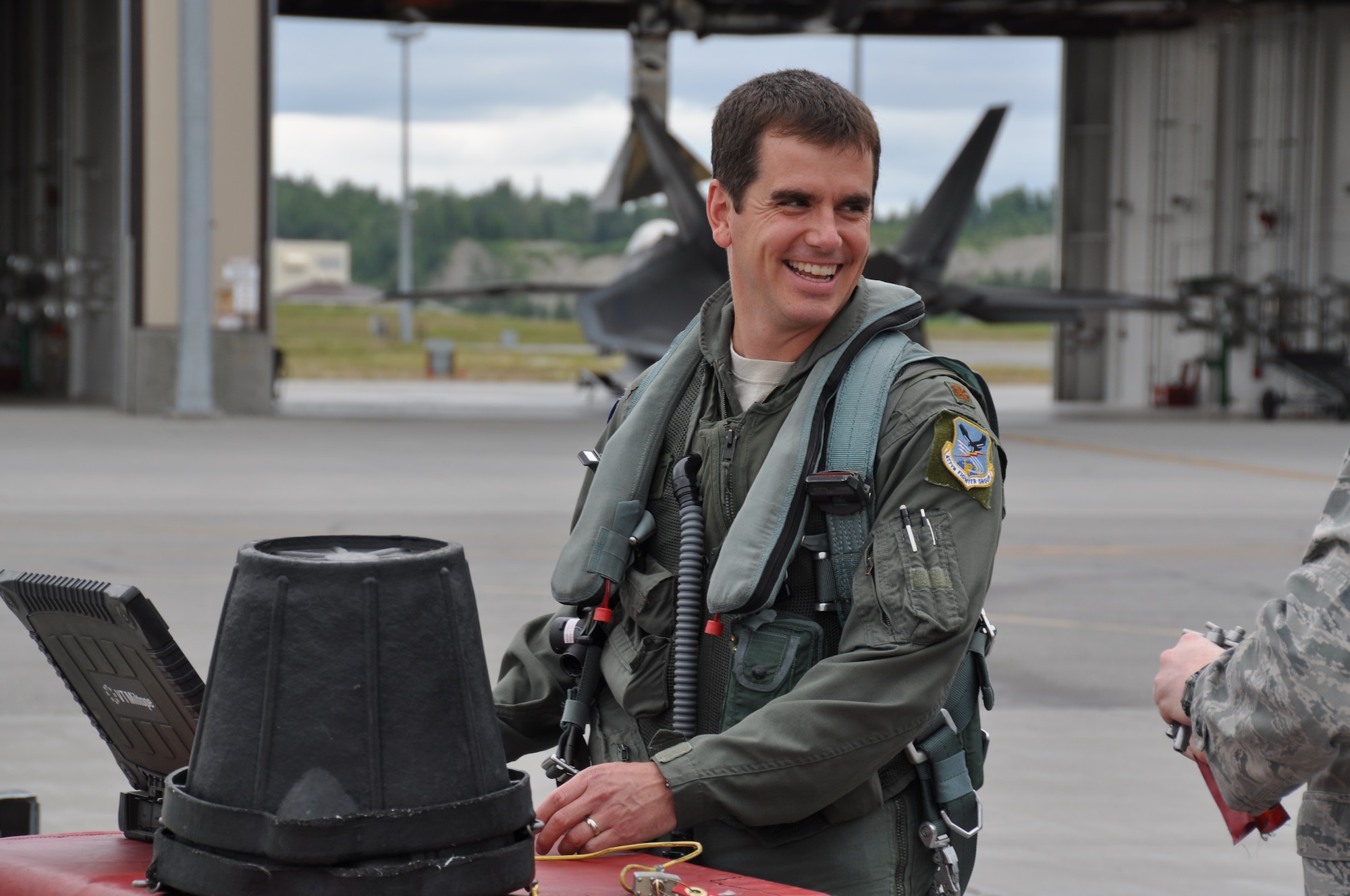 Maj. Wade Bridges, Reserve F-22 pilot assigned to the 302nd Fighter Squadron and Alaska Airlines First Officer, prepares to fly a routine sortie here July 18. Bridges splits his time between flying the F-22 for Alaska’s only Air Force Reserve unit and a Boeing 737 for Alaska Airlines (U.S. Air Force/Capt. Ashley Conner)