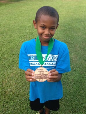 Omari Davis poses for a photo with his medal from the Hershey’s Track and Field North American Finals in Hershey, Pa. Omari son of Tech Sgt. Glenn Davis, 9th Force Support Squadron NCOIC of formal training, finished 5th in the 200-meter dash. (Courtesy photo)