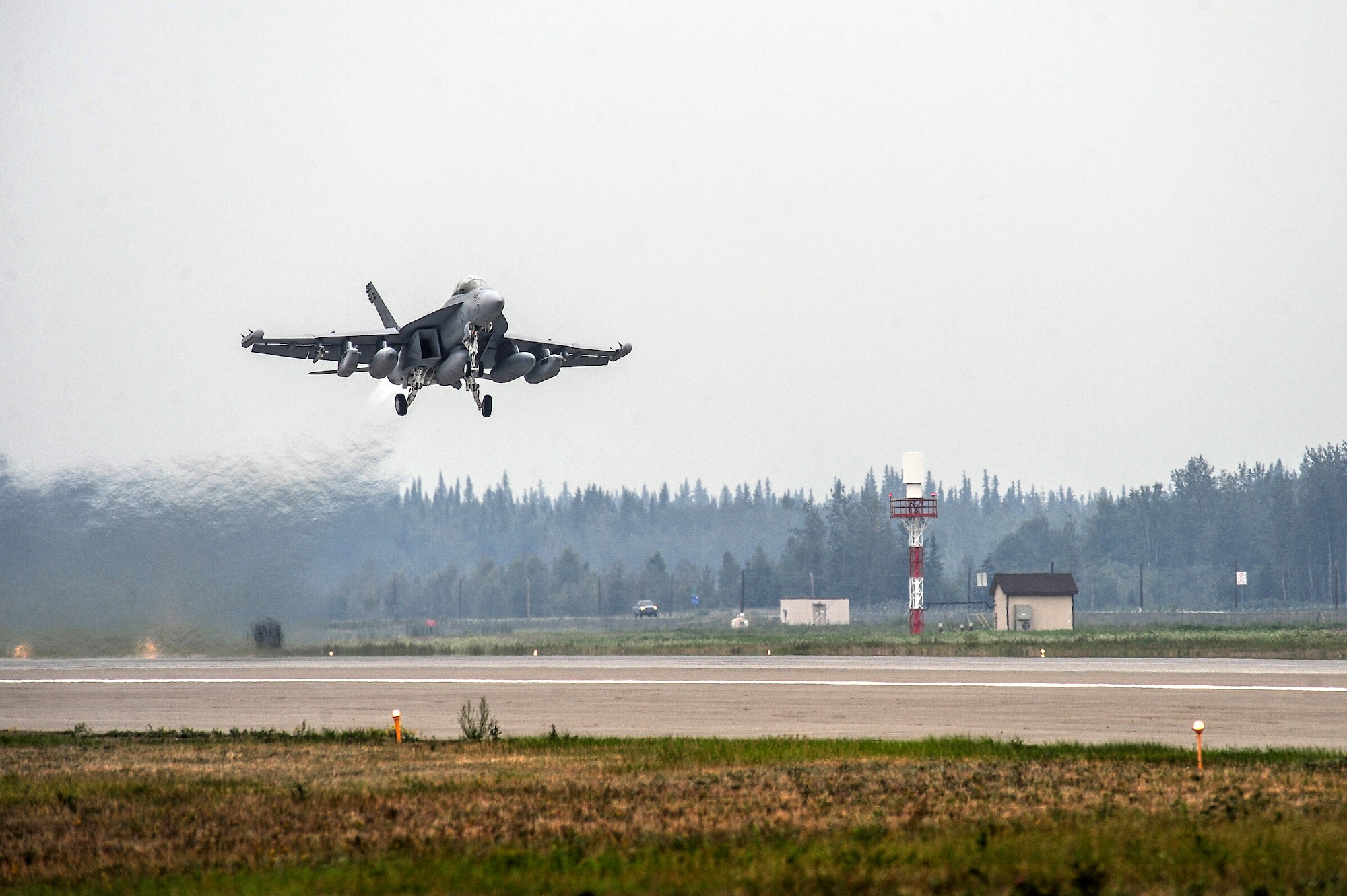A United States Navy F/A-18 Hornet from the 113th Fighter Squadron, Naval Air Station Lemoore, Calif., takes off for a familiarization flight Aug. 9, 2013, Eielson Air Force Base, Alaska. The F/A-18 is a twin-engine supersonic multirole fighter jet designed for air-to-air and air-to-ground combat. (U.S. Air Force photo by Senior Airman Zachary Perras/Released)
