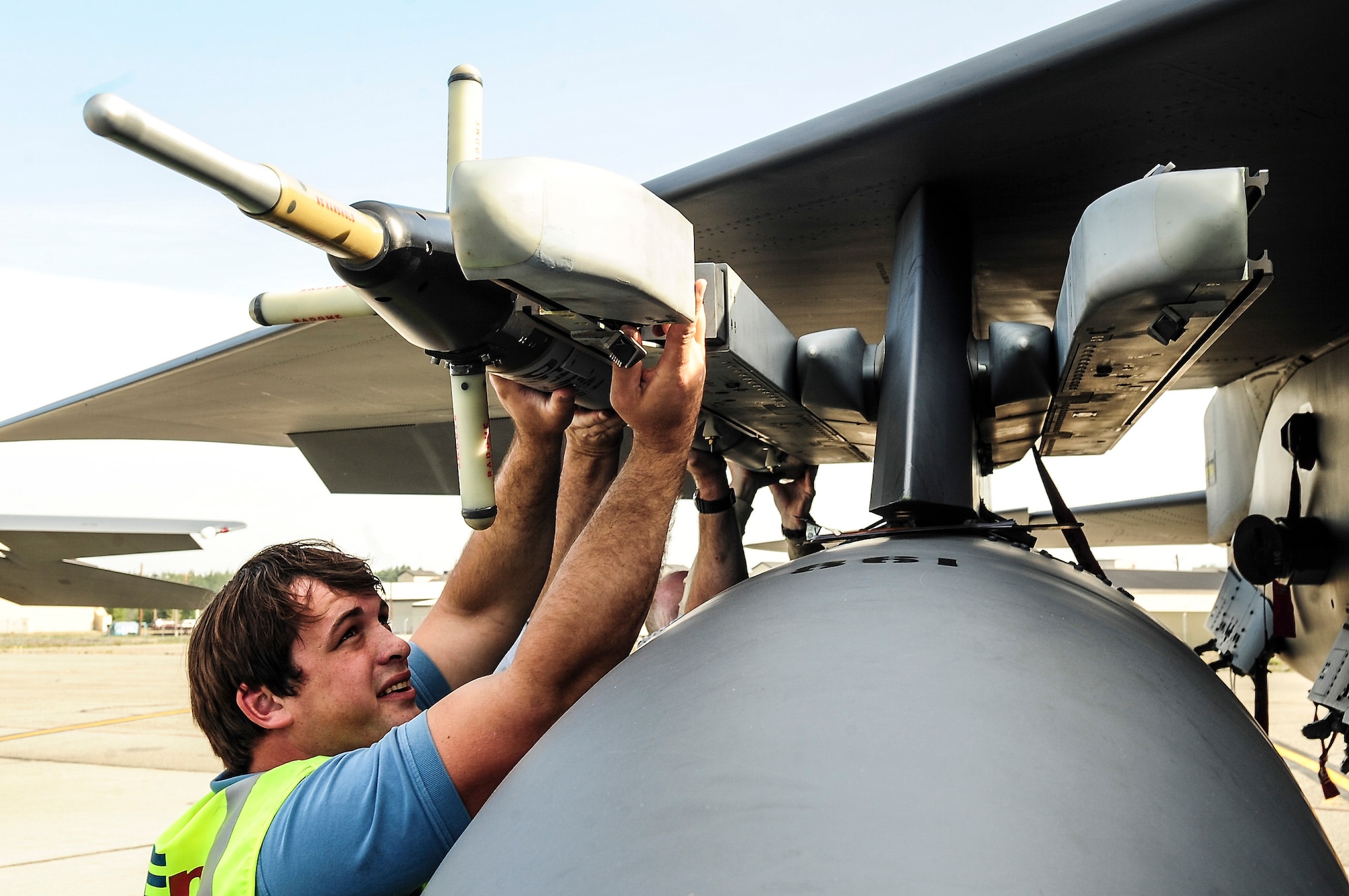 Wes Dear, an electronic technician with Bering Sea Environmental North, attaches an air-combat maneuver instrument pod to a Japan Air-Self Defense Force F-15J Eagle Aug. 8, 2013, Eielson Air Force, Alaska. The pods are attached to aircraft to help monitor movement during flights, which can then be reviewed during post-flight briefings. (U.S. Air Force photo by Senior Airman Zachary Perras/Released)