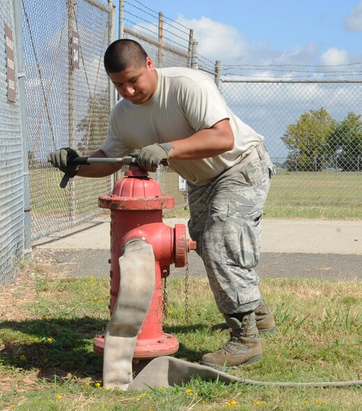 Senior Airman Marc Pacheco, 2nd Civil Engineer Squadron firefighter, opens a hydrant during a training exercise on Barksdale Air Force Base, La., Aug. 12, 2013. The training is held to ensure new firefighters meet all the proper requirements for upgrade. (U.S. Air Force photo/Senior Airman Sean Martin)
